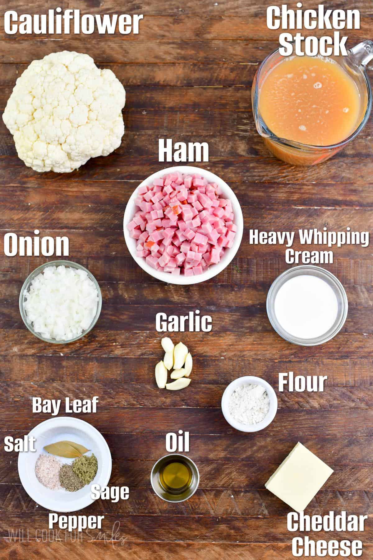 labeled ingredients to make cauliflower ham soup on a wooden board.
