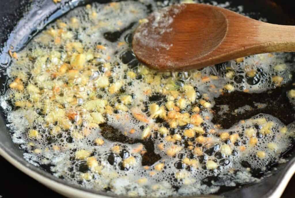 searing minced garlic in the skillet with butter.