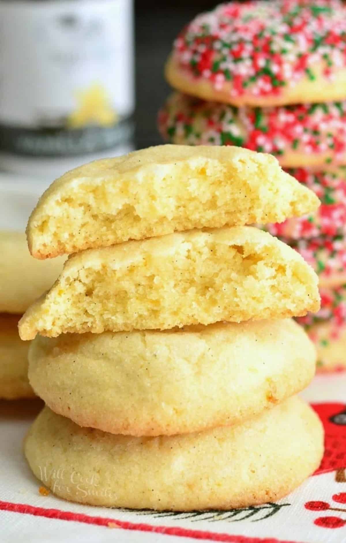 Vanilla bean orange sugar cookies stacked up with the top one cut in half.