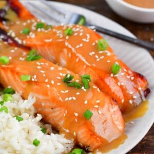 baked salmon with miso glaze topped with sesame seeds and green onion.