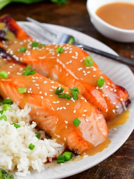 baked salmon with miso glaze topped with sesame seeds and green onion.