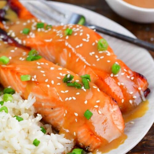 baked salmon with miso glaze topped with sesame seeds and green onion.