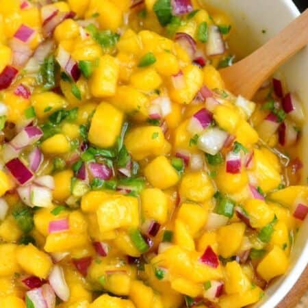 mango salsa with red onion and jalapeno in a bowl.