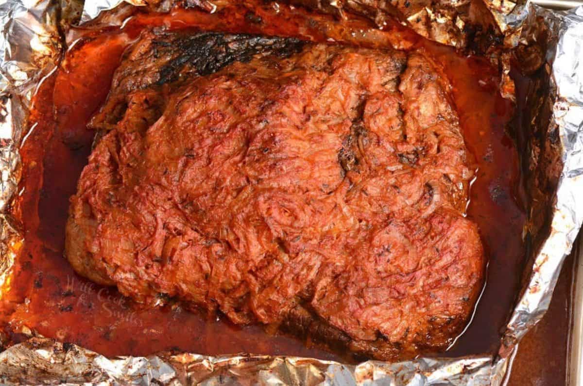 cooked French onion beef brisket in the roasting pan in foil.