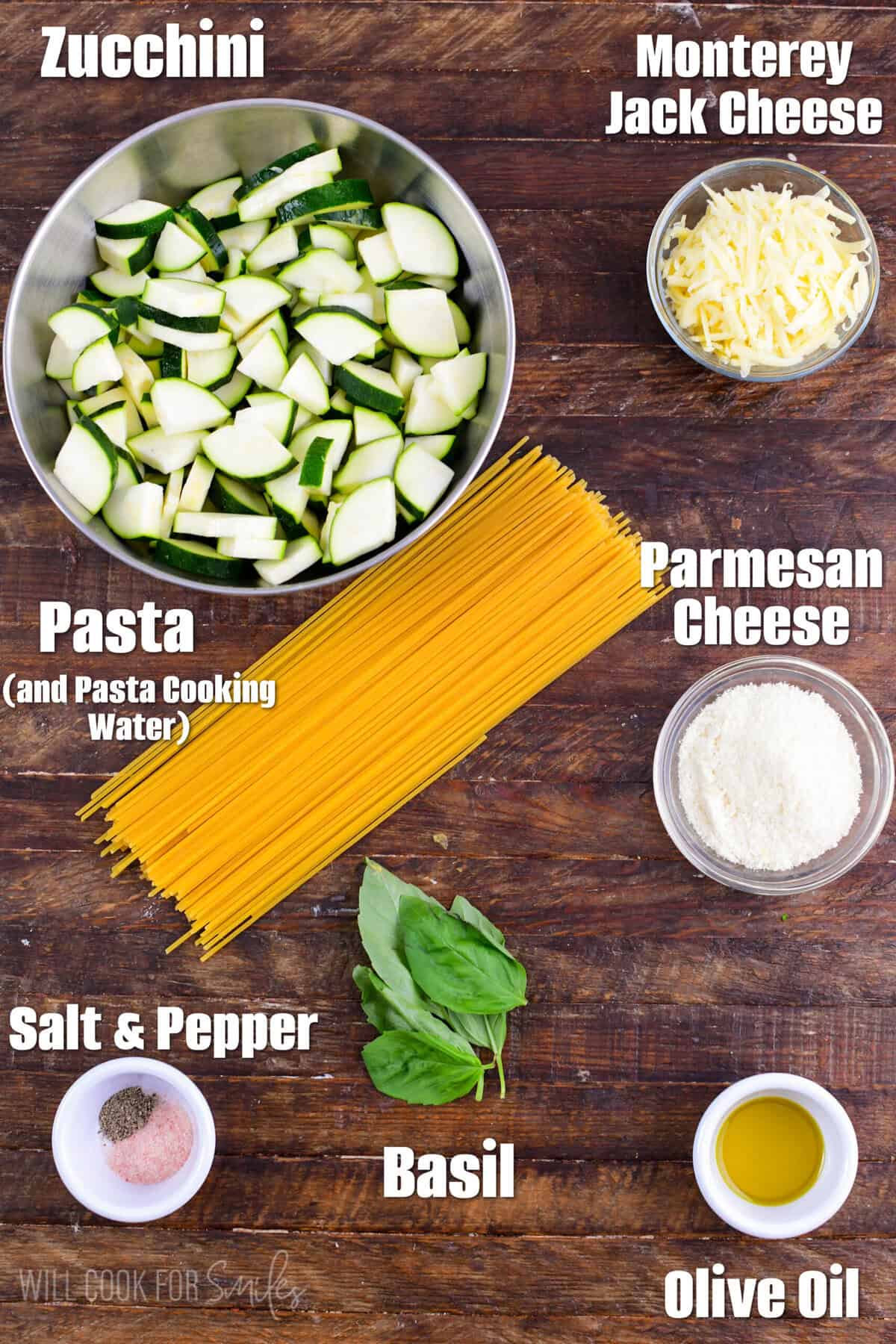 Labeled Ingredients for Zucchini Pasta on a wood surface.