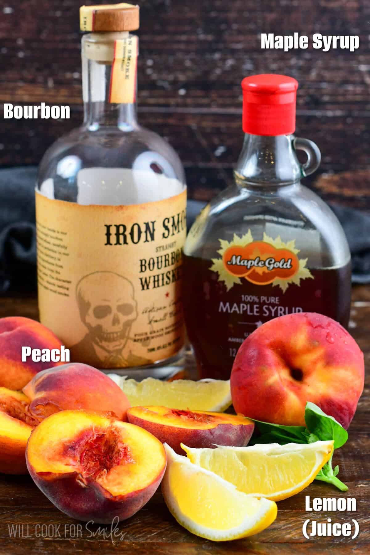 Peach bourbon smash ingredients on a wood surface.