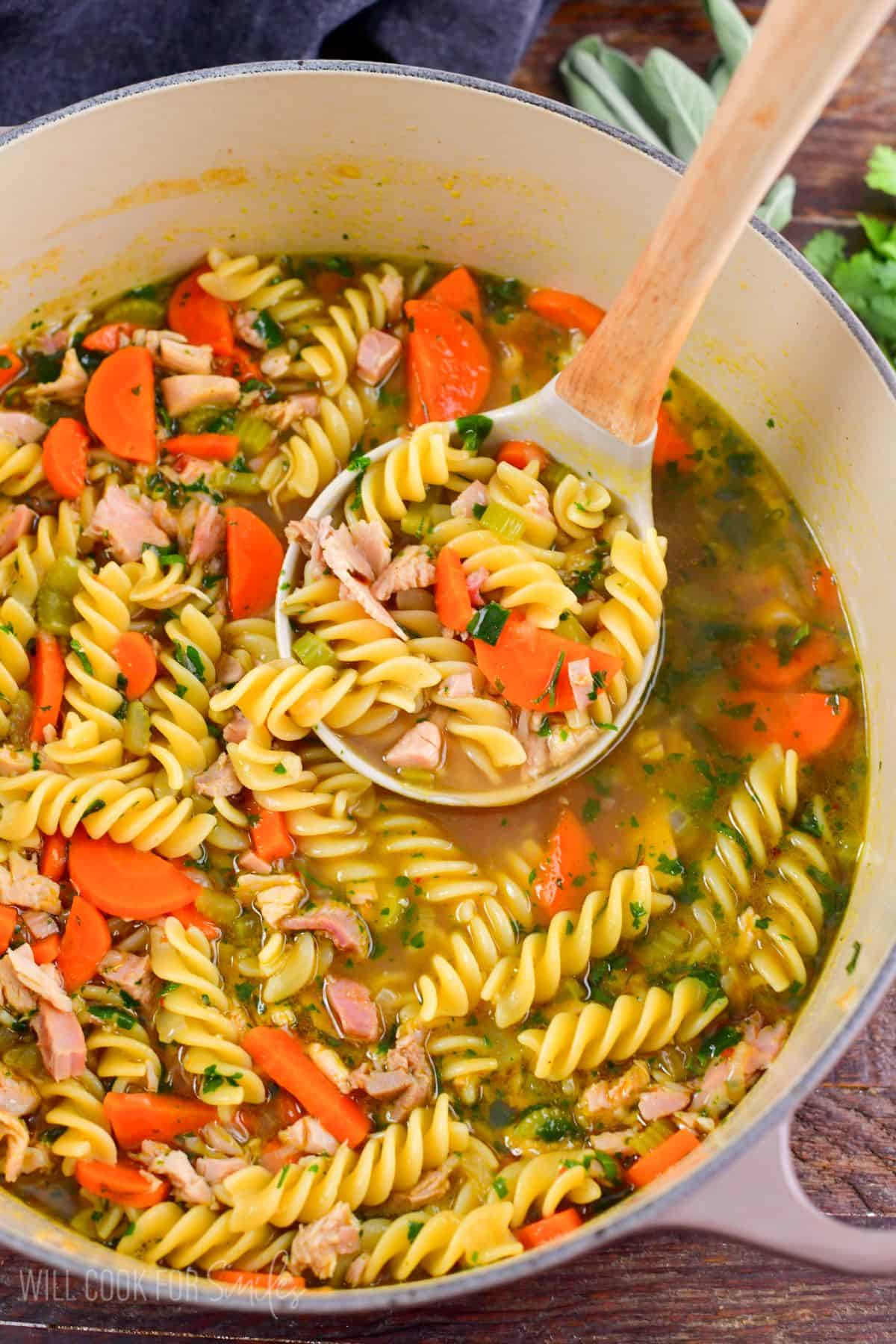 Hearty turkey noodle soup featuring leftover turkey, sautéed vegetables, fresh herbs, and soft noodles in a rich broth.