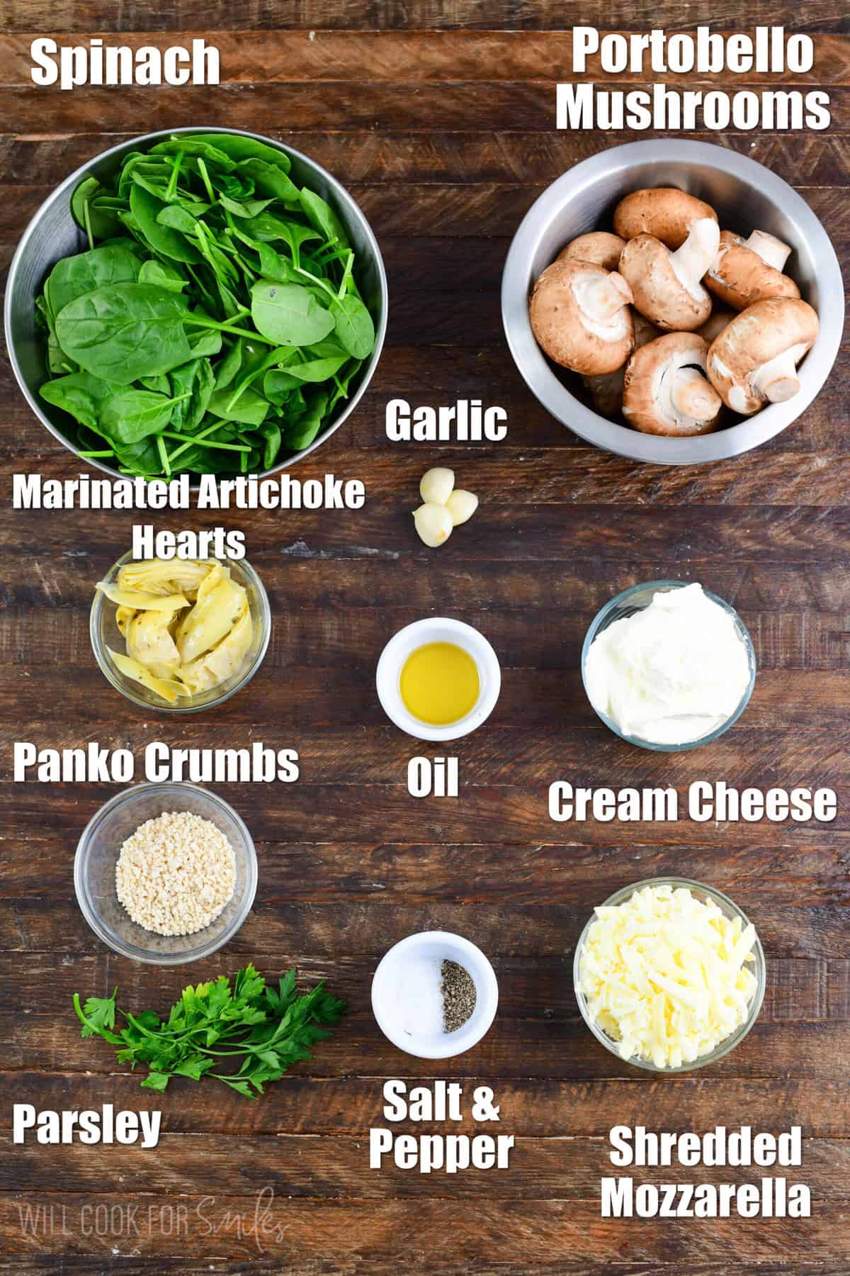 labeled ingredients to make spinach artichoke stuffed mushrooms on a wooden board.