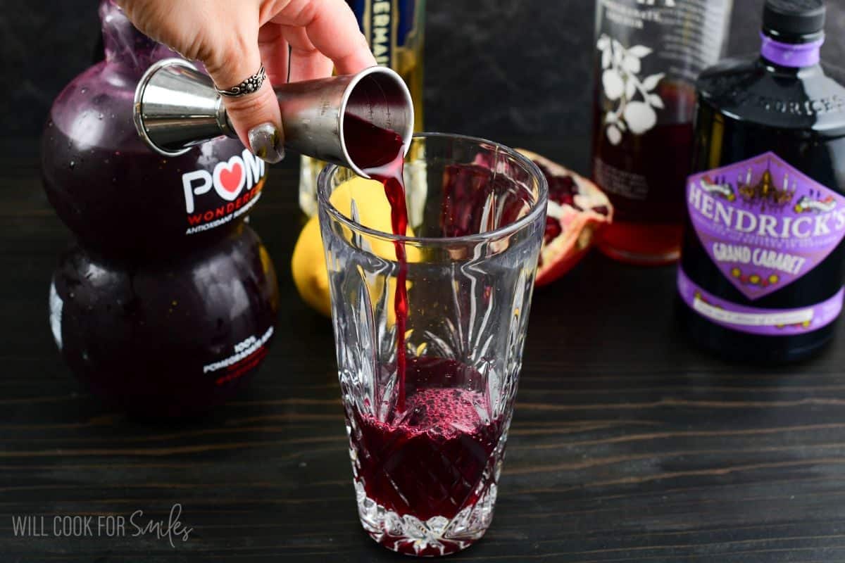 adding rich and fruity pomegranate juice to the cocktail shaker.