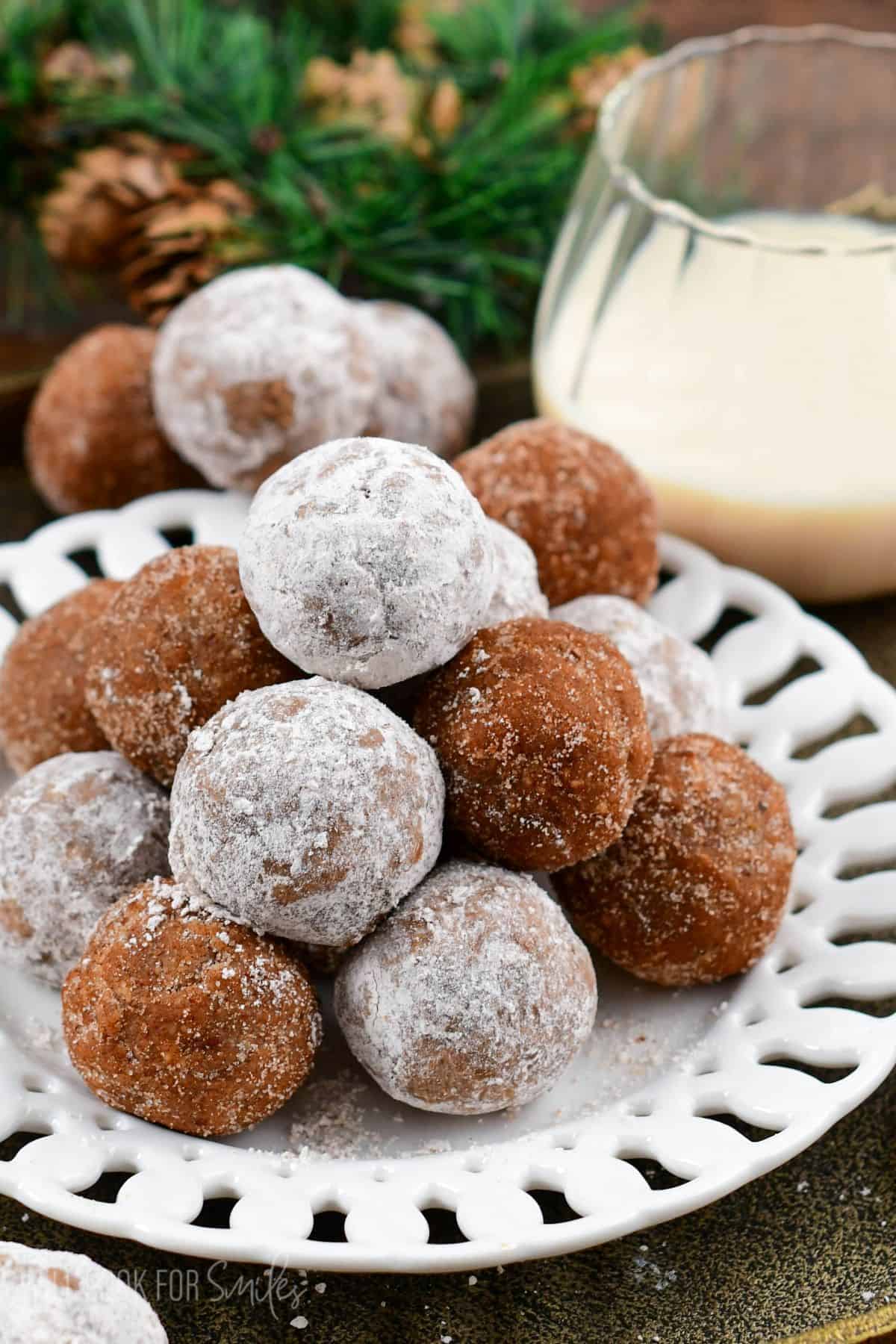 Rumchata rum balls stacked up on top of each other on a plate.