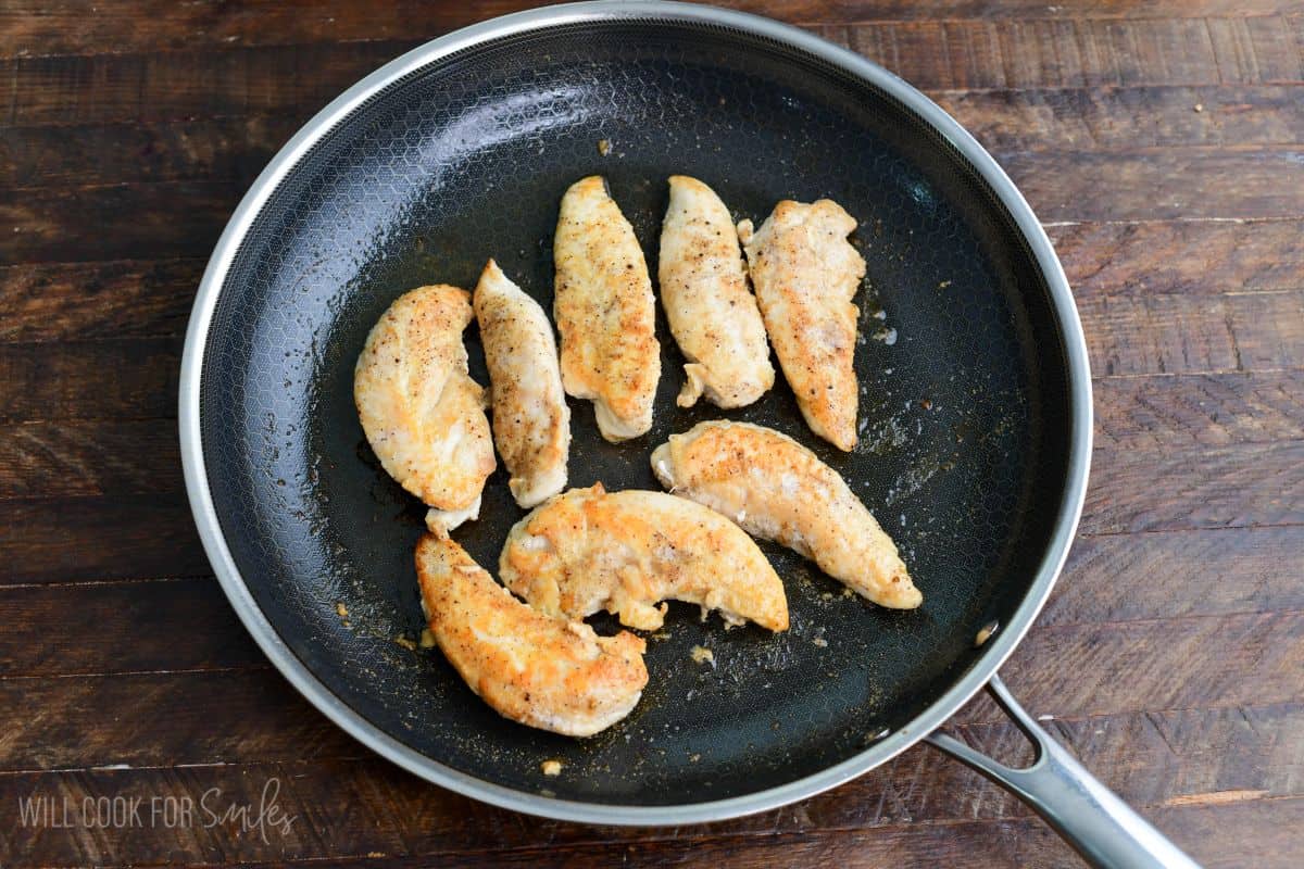 Seasoned chicken tenderloins cooked in a skillet until lightly browned for jalapeño ranch chicken sliders.