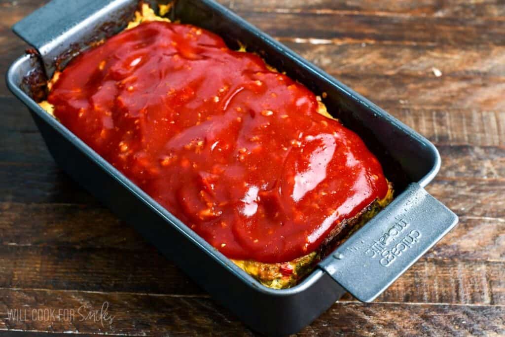 Turkey meatloaf in a loaf pan fully baked and topped with a thick, glossy ketchup glaze.