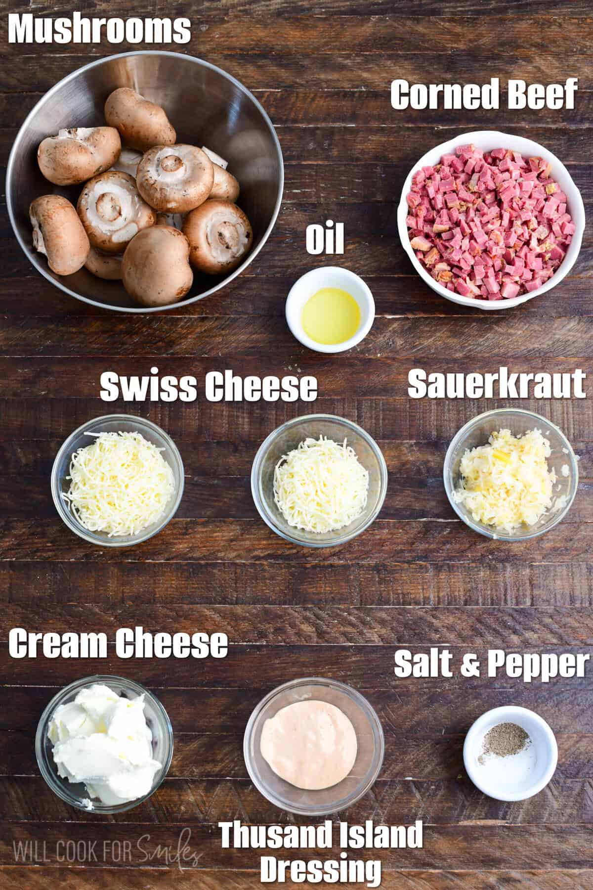 labeled ingredients for Reuben stuffed mushrooms on a wooden board.