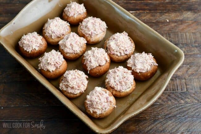 stuffed mushroom camps with Reuben filling in the baking dish.