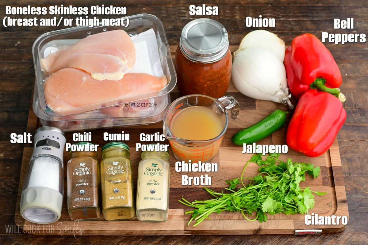 labeled ingredients to make salsa chicken on the wooden cutting board.