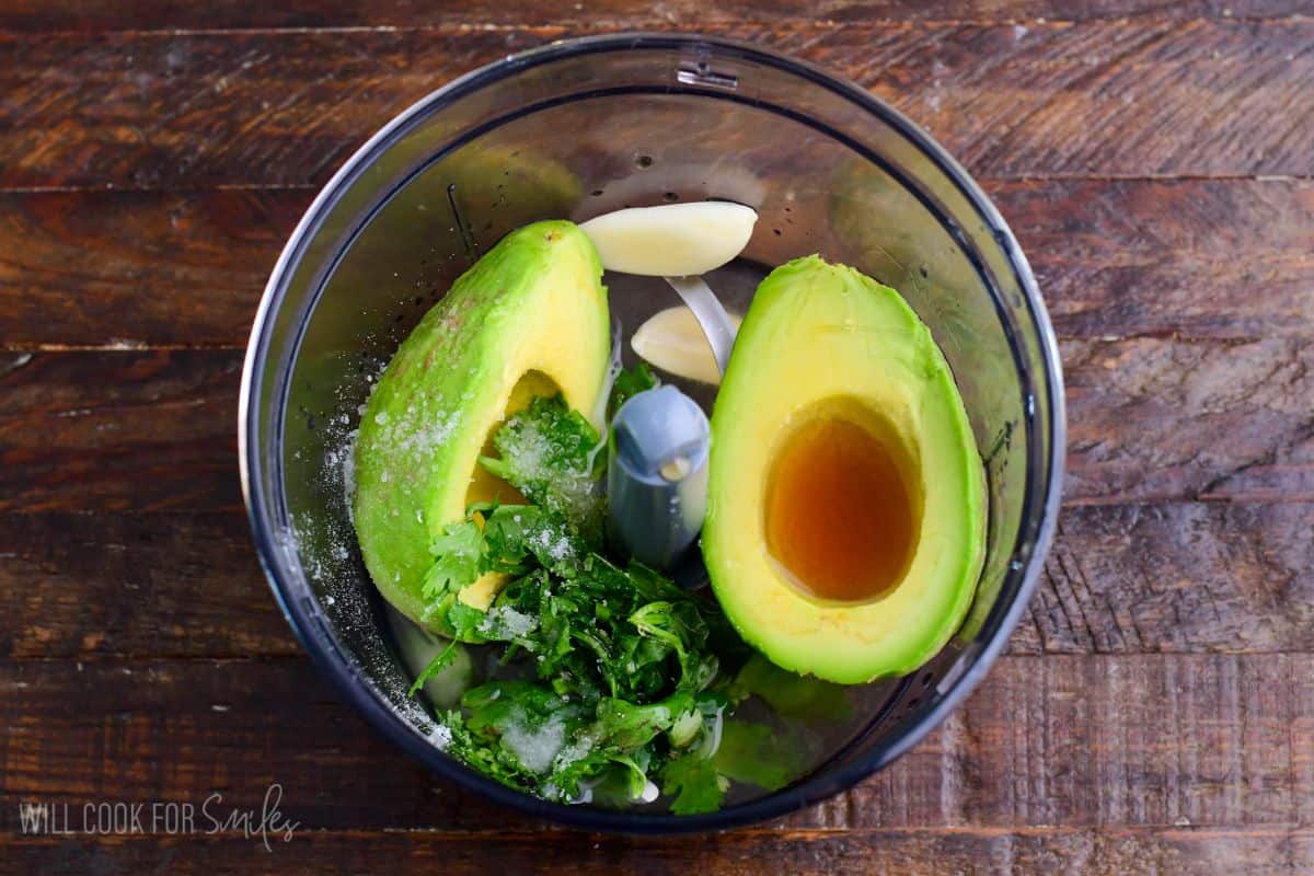ingredients for avocado dressing in a blender before blending.