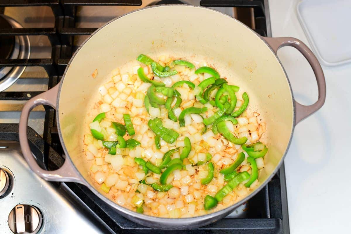 diced white onions and sliced jalapenos sautéing in the Dutch oven.