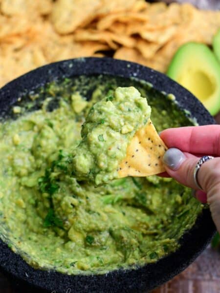some Oaxacan guacamole scooped onto the tortilla chip.