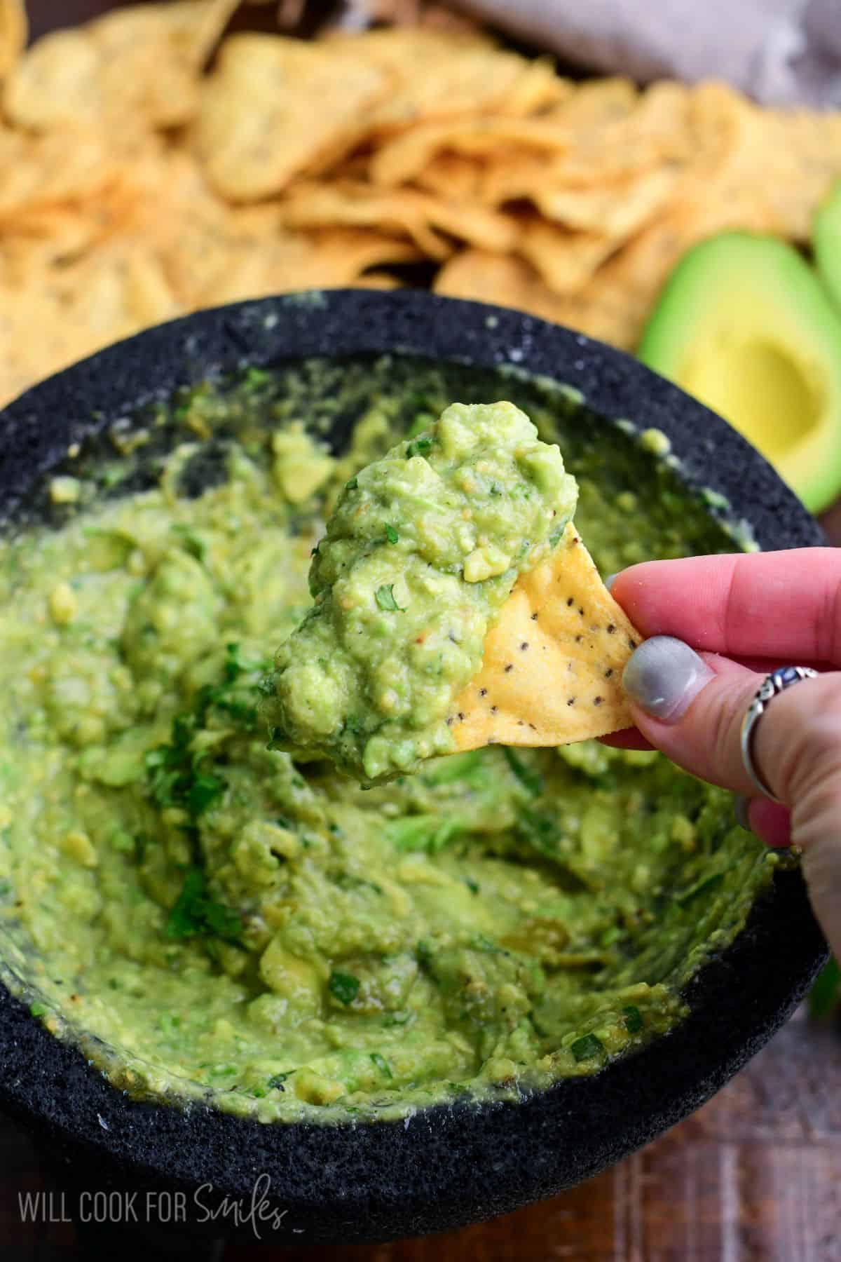 some Oaxacan guacamole scooped onto the tortilla chip.