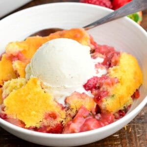 a big bowl of warm lemon basil strawberry cobbler with ice cream on top, melting.