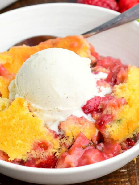 a big bowl of warm lemon basil strawberry cobbler with ice cream on top, melting.