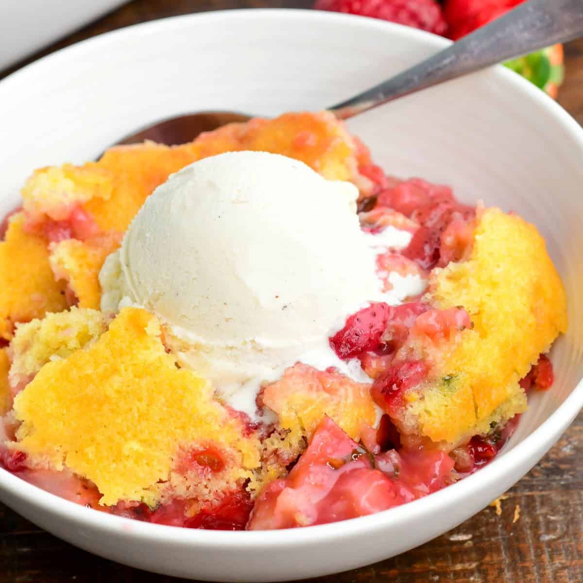 a big bowl of warm lemon basil strawberry cobbler with ice cream on top, melting.