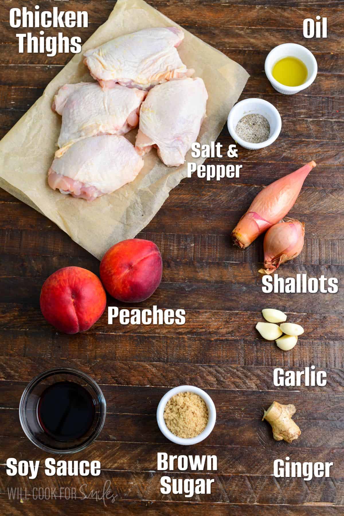 labeled ingredients for baked peach chicken on a wood surface.