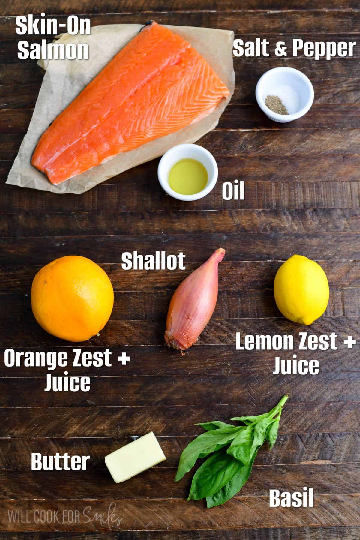 labeled ingredients for grilled salmon with citrus sauce on a wood surface,