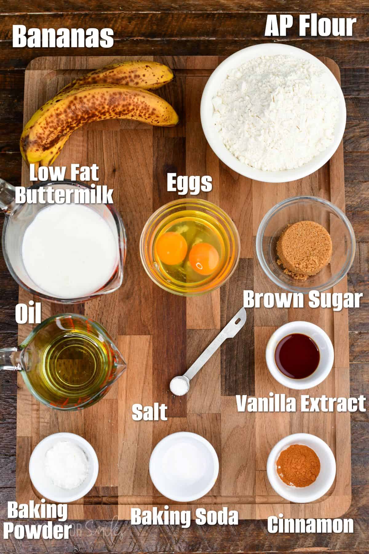 Lableled ingredients for banana pancakes on a wood surface.