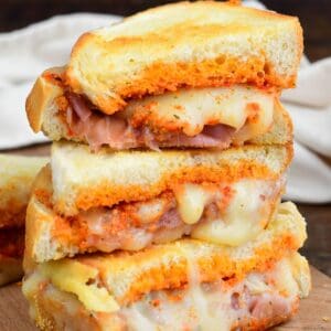 Sun dried tomato pesto grilled cheese sliced and three halves stacked.