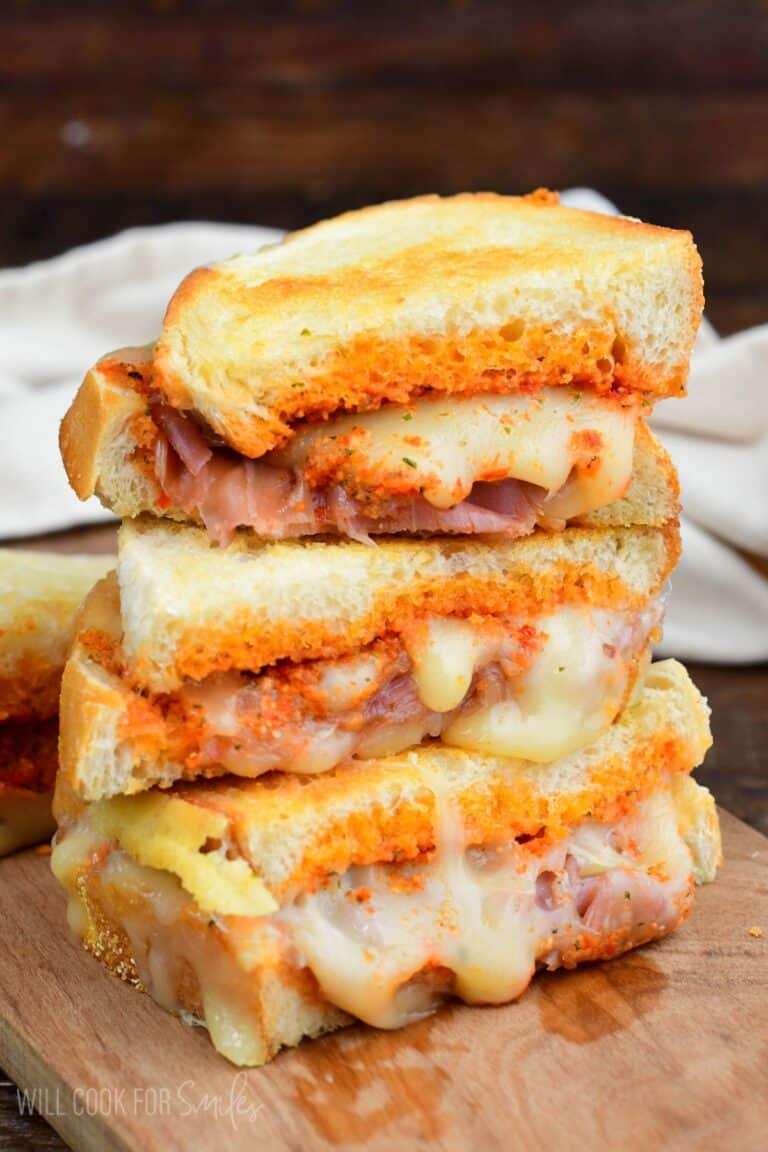 Sun dried tomato pesto grilled cheese sliced and three halves stacked.