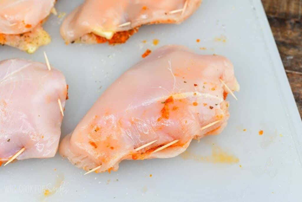 Stuffed chicken breasts secured with toothpicks, filled with sun dried tomato pesto and fontina cheese.