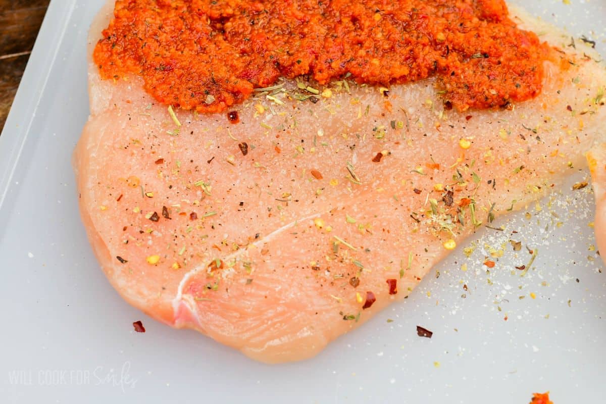 Butterflied chicken breast seasoned and topped with sun dried tomato pesto before stuffing.