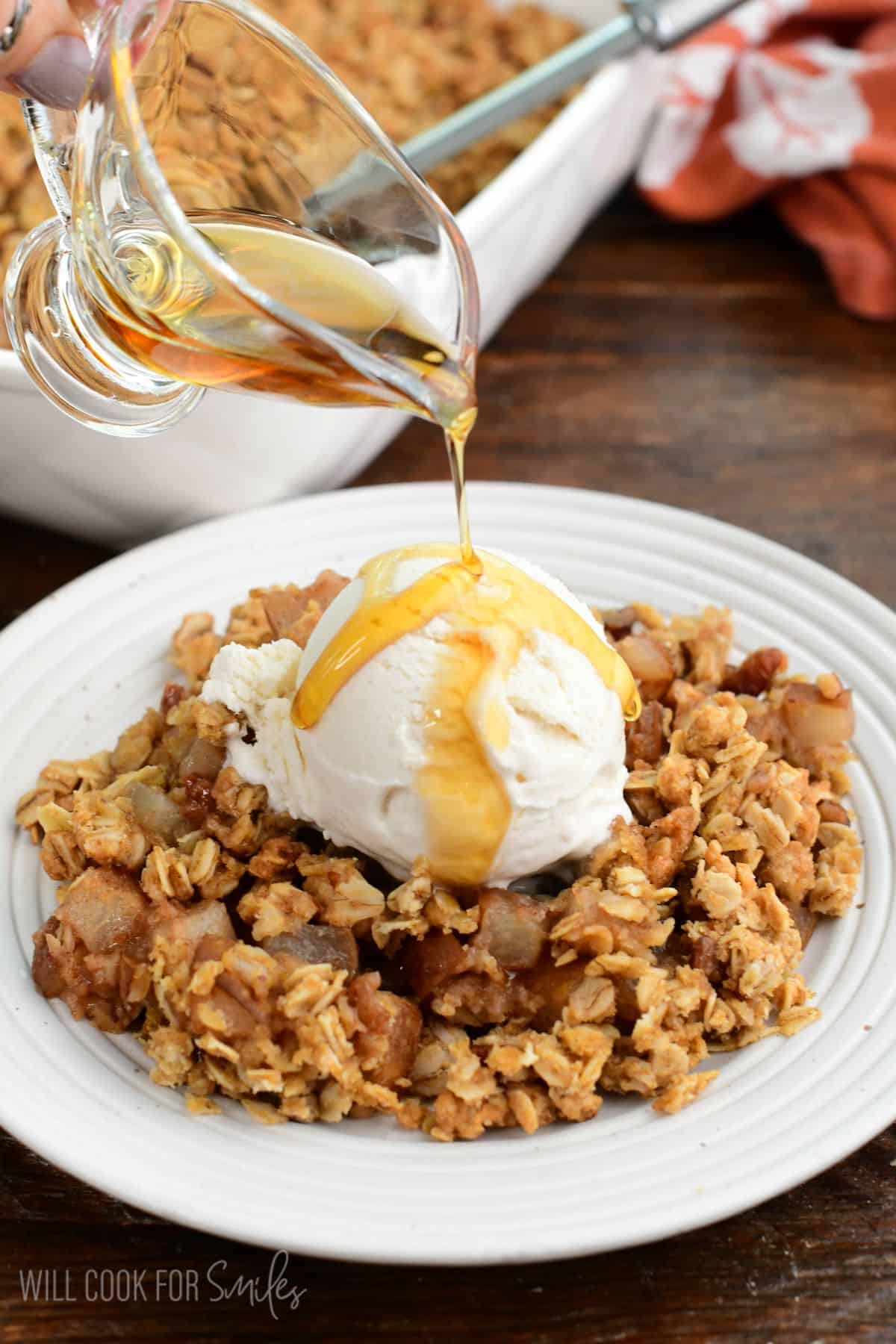 Asian pear crisp topped with vanilla ice cream and a drizzle of sweet maple syrup.