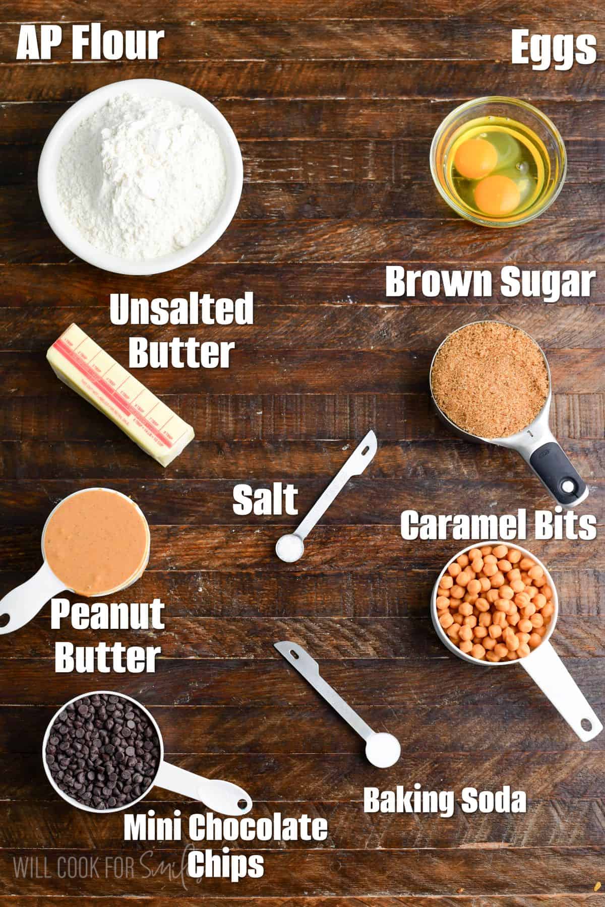labeled ingredients for sumbitches-Peanut Butter Chocolate and Caramel Cookies on a wood surface.