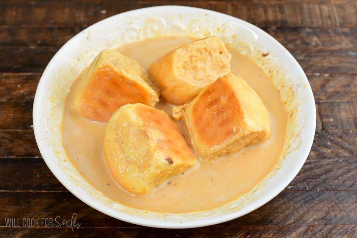 soaking four filled Hawaiian rolls in the pumpkin egg custard.