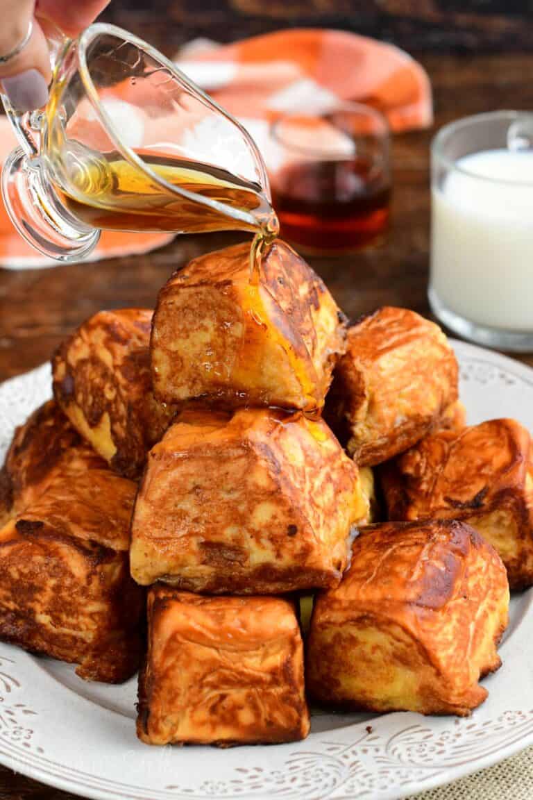 Pumpkin cheesecake stuffed Hawaiian French toast bites drizzled with maple syrup.