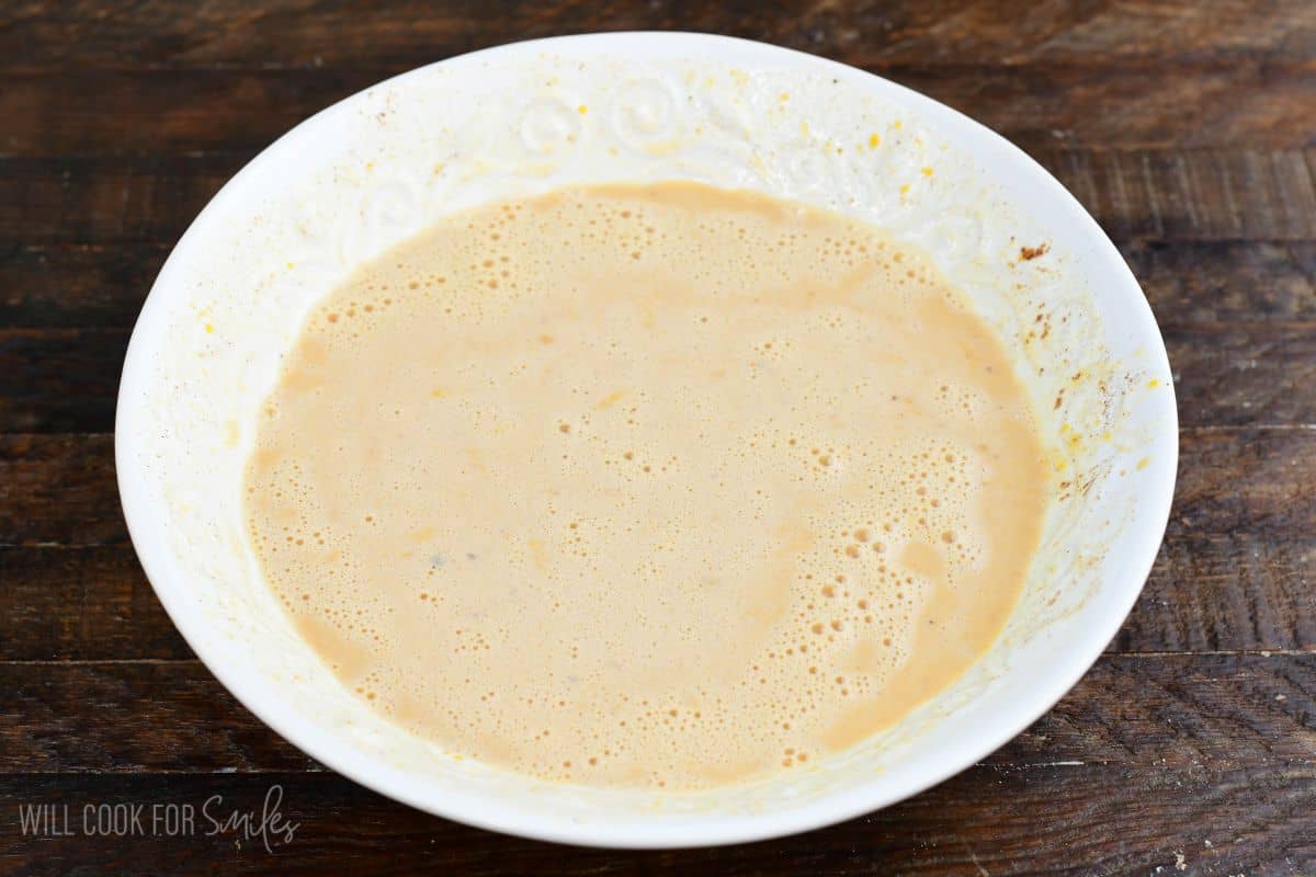 Whisked egg custard mixture for pumpkin cheesecake stuffed Hawaiian French toast.