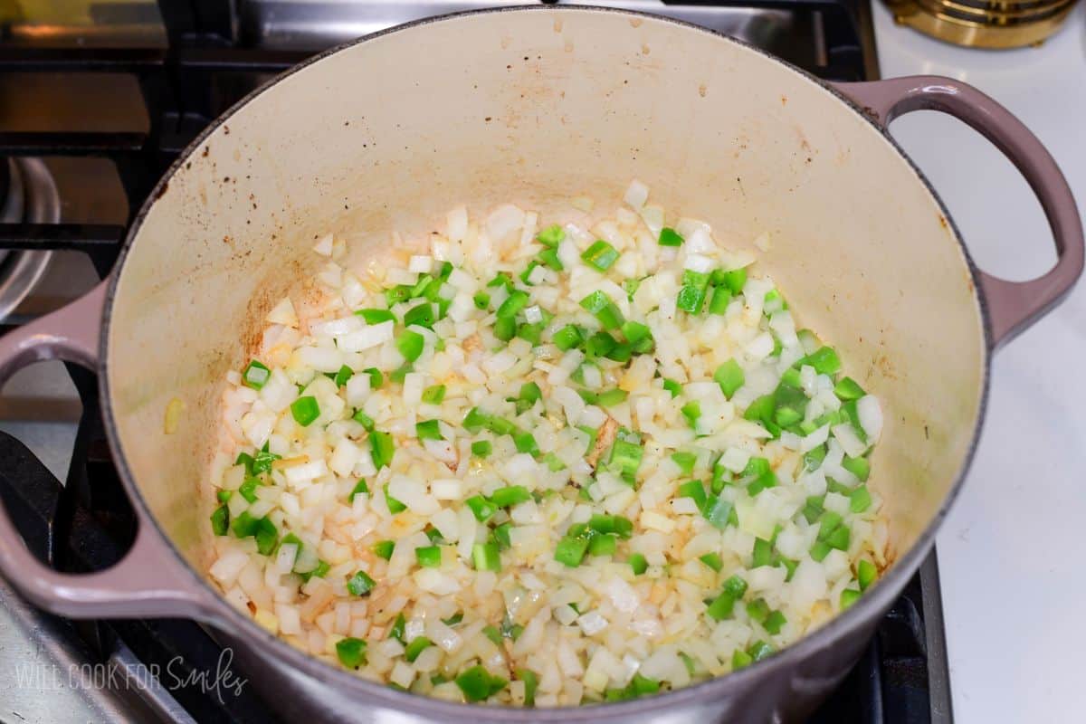 Onions and green peppers sautéing in a Dutch oven for homemade short rib chili.